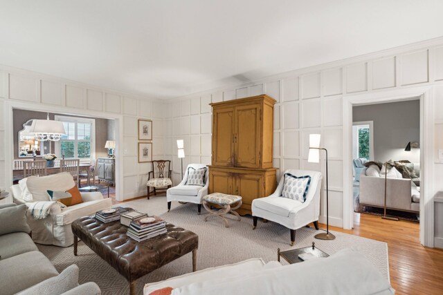 living room with ornamental molding and light hardwood / wood-style floors