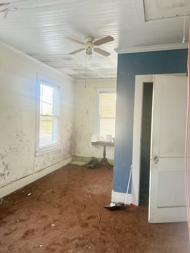 spare room featuring ornamental molding and ceiling fan