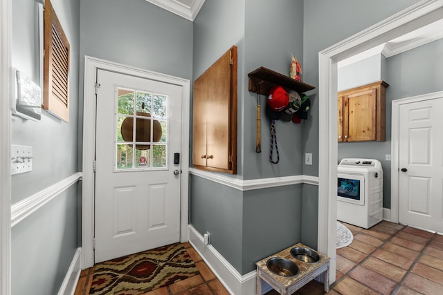 doorway with crown molding, light tile patterned flooring, and washer / dryer