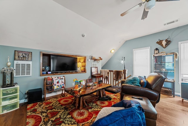 living room featuring vaulted ceiling, ceiling fan, and wood-type flooring