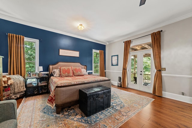 bedroom featuring ceiling fan, access to exterior, hardwood / wood-style flooring, ornamental molding, and french doors