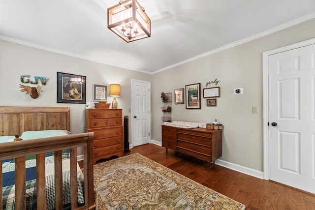 bedroom with dark hardwood / wood-style floors and ornamental molding