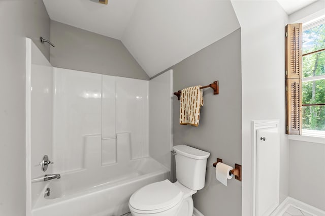 bathroom with lofted ceiling, shower / bathing tub combination, toilet, and tile patterned floors