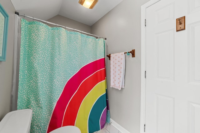 bathroom with vaulted ceiling and toilet