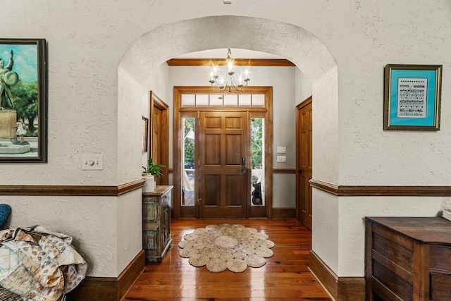 foyer featuring dark hardwood / wood-style floors and a chandelier