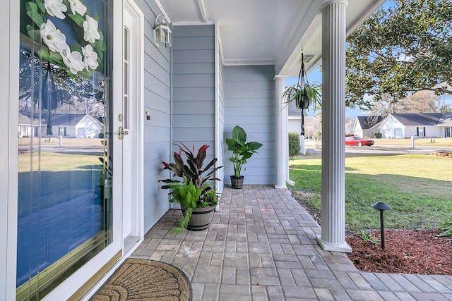 view of patio / terrace with a residential view and a porch