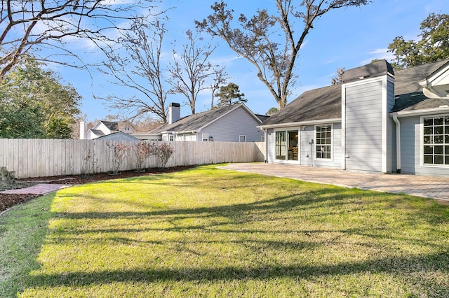 view of yard with fence and a patio