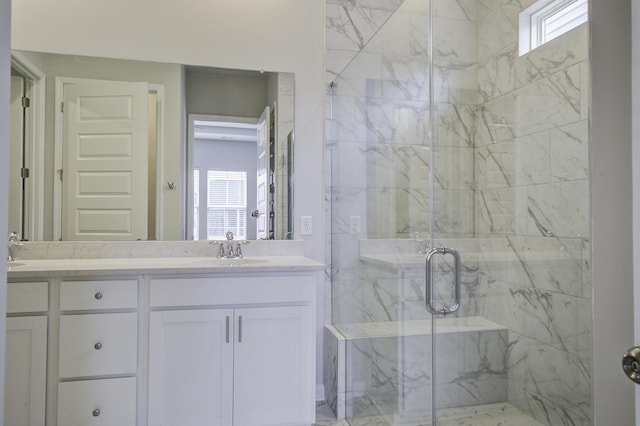 bathroom with a wealth of natural light, vanity, and an enclosed shower