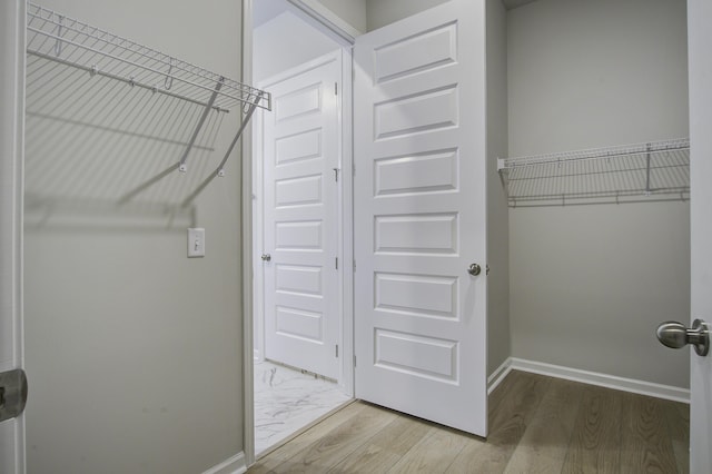 walk in closet featuring hardwood / wood-style flooring