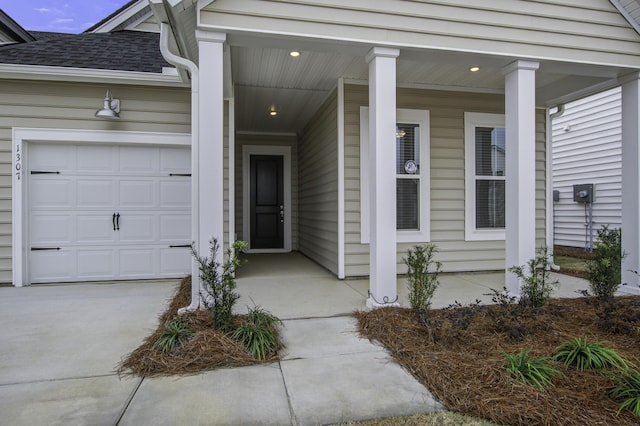 property entrance with a porch and a garage