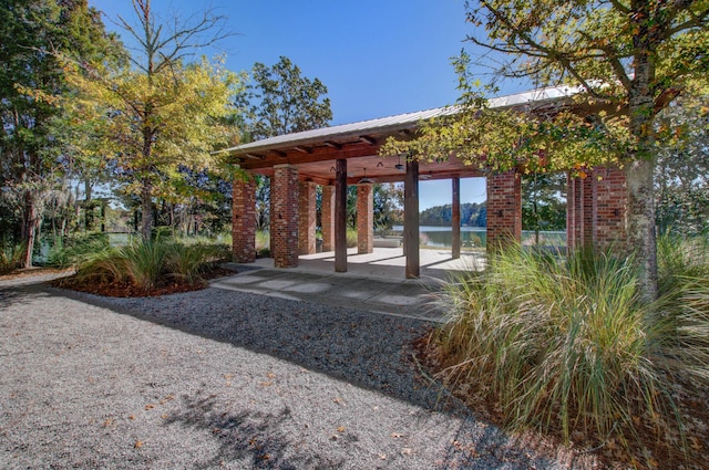 view of patio with a gazebo and a water view