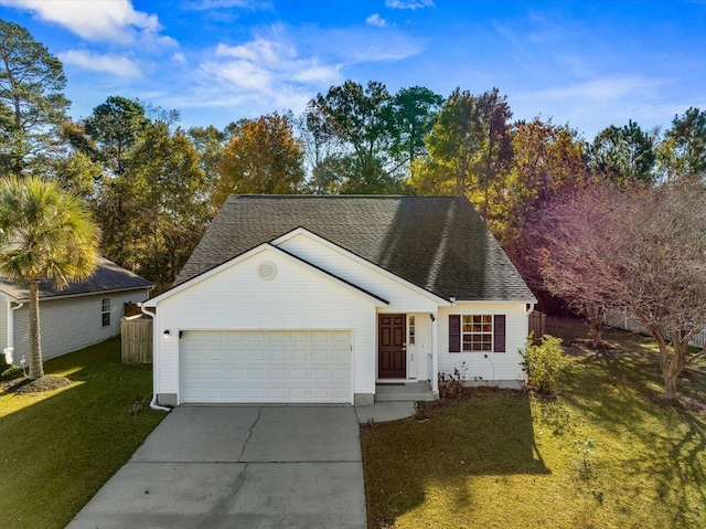 view of front of home with a front yard and a garage