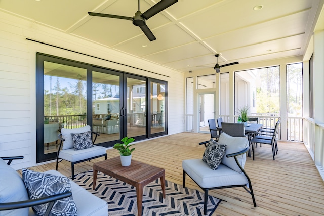 sunroom / solarium with a ceiling fan and a wealth of natural light