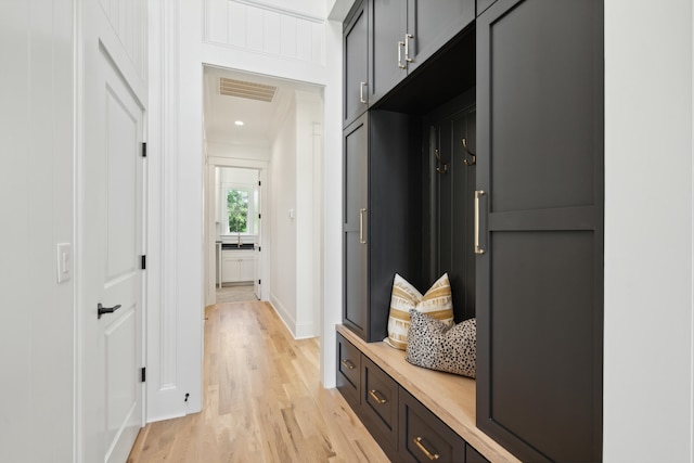 mudroom featuring visible vents and light wood-style flooring