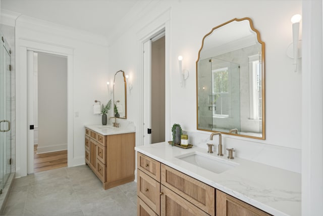 bathroom with crown molding, a shower with shower door, double vanity, and hardwood / wood-style floors