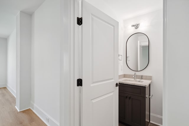 bathroom with vanity and hardwood / wood-style flooring