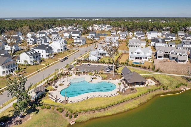 drone / aerial view with a residential view and a water view