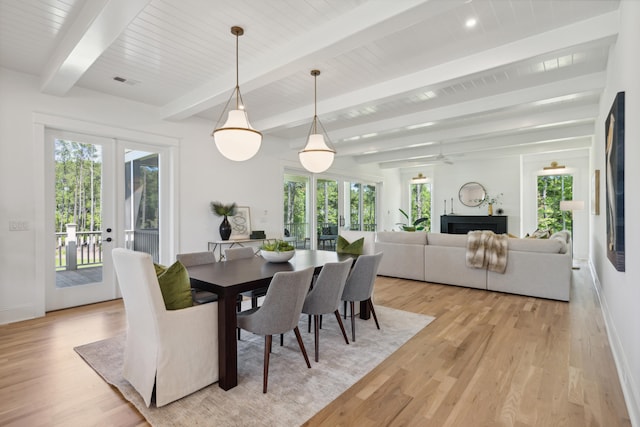 dining room featuring light hardwood / wood-style floors, ceiling fan, and beam ceiling