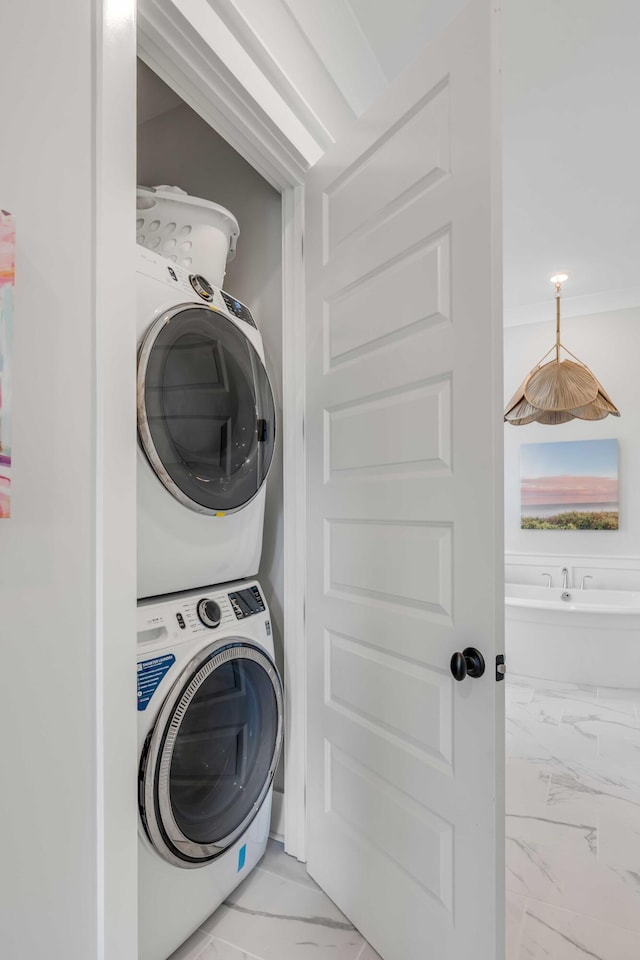 laundry area featuring stacked washer and dryer