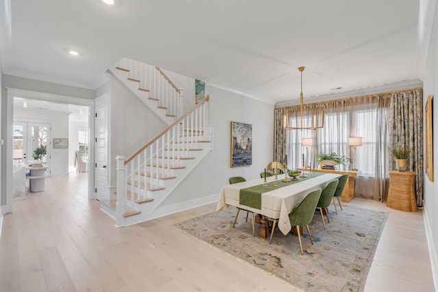 dining room featuring ornamental molding, a healthy amount of sunlight, and light hardwood / wood-style flooring