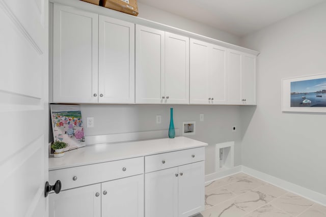 laundry area with cabinets, hookup for an electric dryer, and hookup for a washing machine