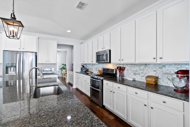 3203 Moonlight Dr, Charleston, SC 29414 - kitchen featuring stainless steel appliances, a sink, white cabinetry, recessed lighting, and dark wood finished floors