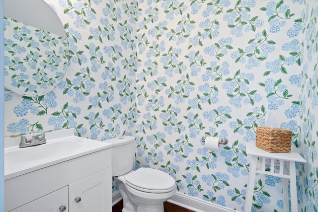 3203 Moonlight Dr, Charleston, SC 29414 - bathroom with wallpapered walls, vanity, toilet, baseboards, and wood finished floors