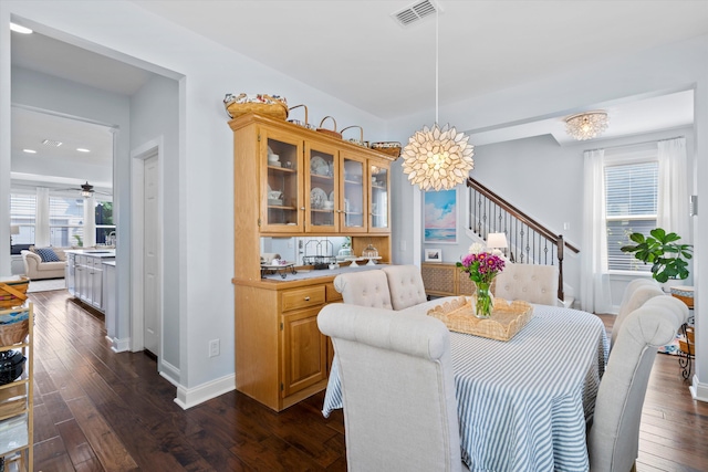 3203 Moonlight Dr, Charleston, SC 29414 - dining space with stairs, dark wood-type flooring, baseboards, a chandelier, and recessed lighting