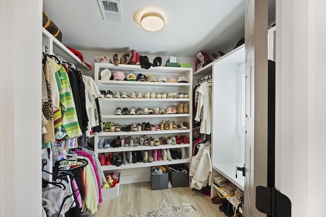 walk in closet with visible vents and wood finished floors