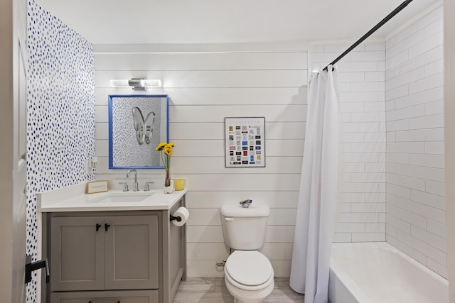 full bathroom with shower / bath combo with shower curtain, toilet, and vanity