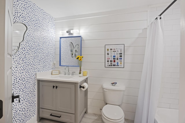 full bathroom featuring vanity, shower / bathtub combination with curtain, toilet, and wood finished floors