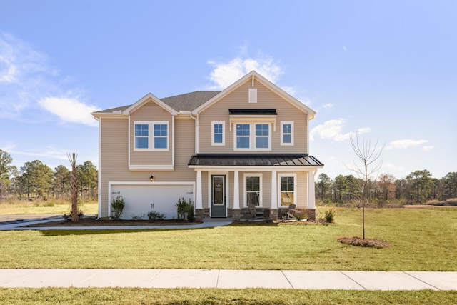 view of front of house featuring a garage, a front yard, and covered porch