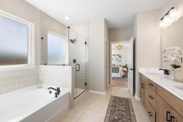 bathroom with vanity, tile patterned floors, and shower with separate bathtub