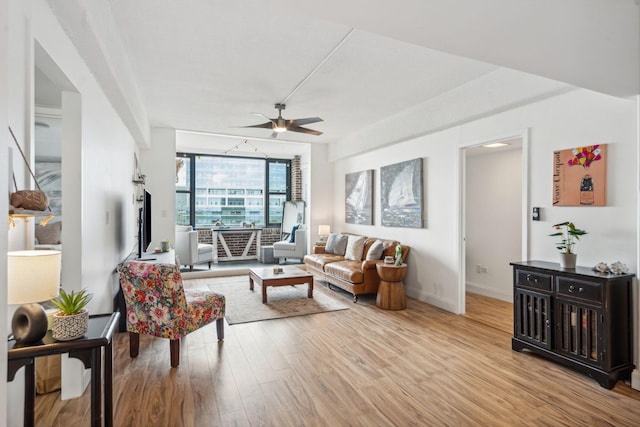 living room with light wood-type flooring and ceiling fan