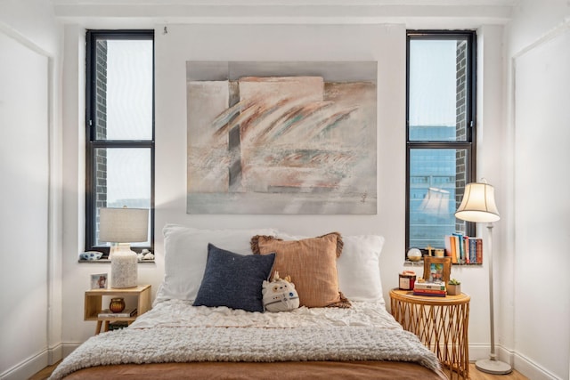 bedroom featuring multiple windows and wood-type flooring