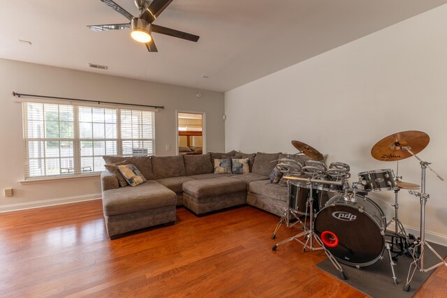 living room with hardwood / wood-style flooring and ceiling fan