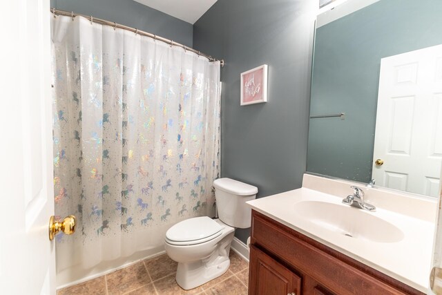 bathroom featuring shower / bath combination with curtain, toilet, vanity, tile patterned flooring, and baseboards