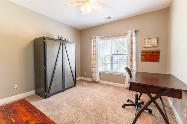 home office with light carpet, visible vents, and baseboards