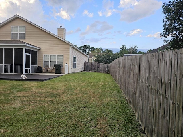 view of yard with a patio area and a sunroom