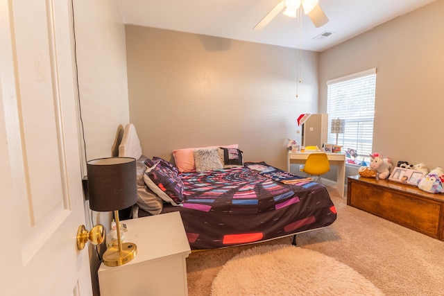 carpeted bedroom featuring visible vents and a ceiling fan