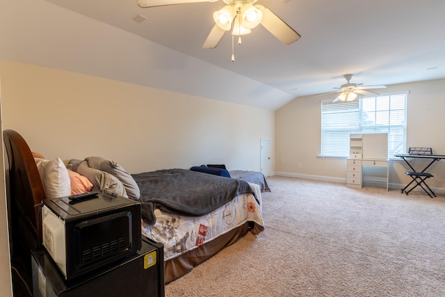 carpeted bedroom featuring lofted ceiling, ceiling fan, and baseboards