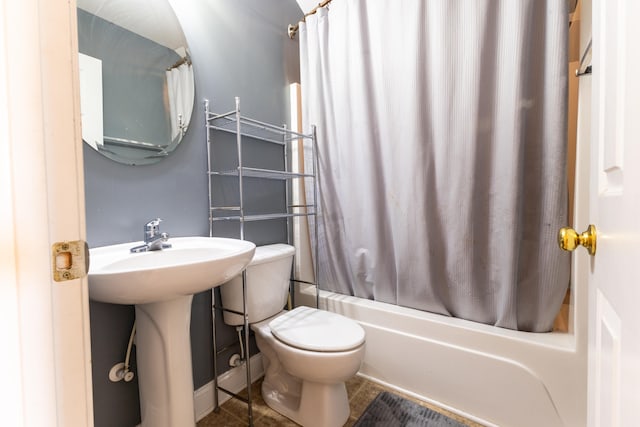 bathroom with toilet, shower / tub combo with curtain, and tile patterned flooring