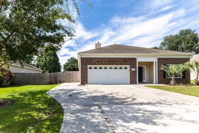 ranch-style home with brick siding, an attached garage, a front yard, fence, and driveway