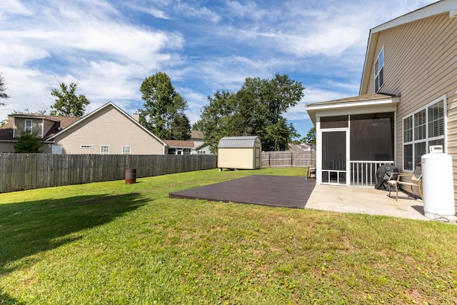 view of yard with a patio, a storage unit, and a sunroom