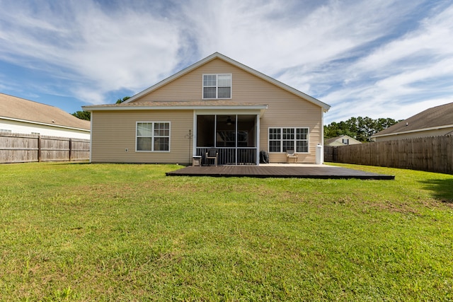 back of house featuring a lawn, a fenced backyard, and a wooden deck