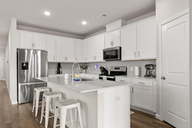 215 Cypress Plantation Rd, Moncks Corner, SC 29461 - kitchen with appliances with stainless steel finishes, a sink, backsplash, a breakfast bar, and a center island with sink