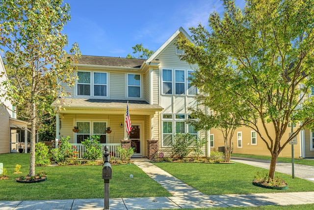 view of front of house with a porch and a front lawn