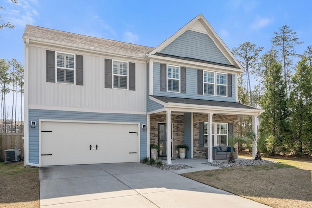 view of front of property featuring roof with shingles, covered porch, concrete driveway, an attached garage, and cooling unit