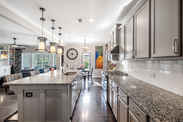 kitchen with appliances with stainless steel finishes, gray cabinets, visible vents, and a sink