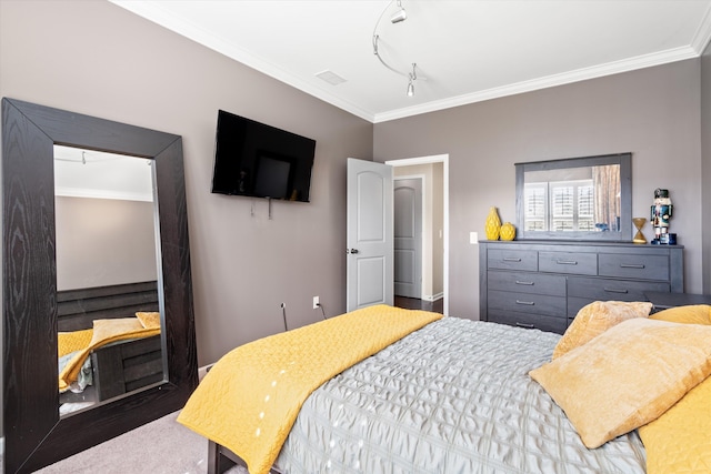 bedroom featuring wood finished floors, visible vents, and crown molding